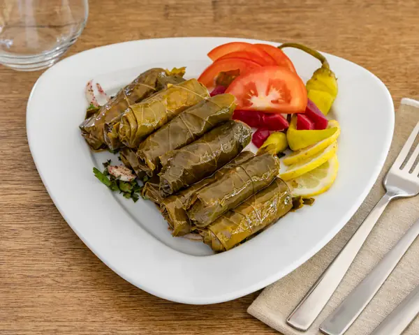 Vine leaves rolled with tomato, rice and herbs